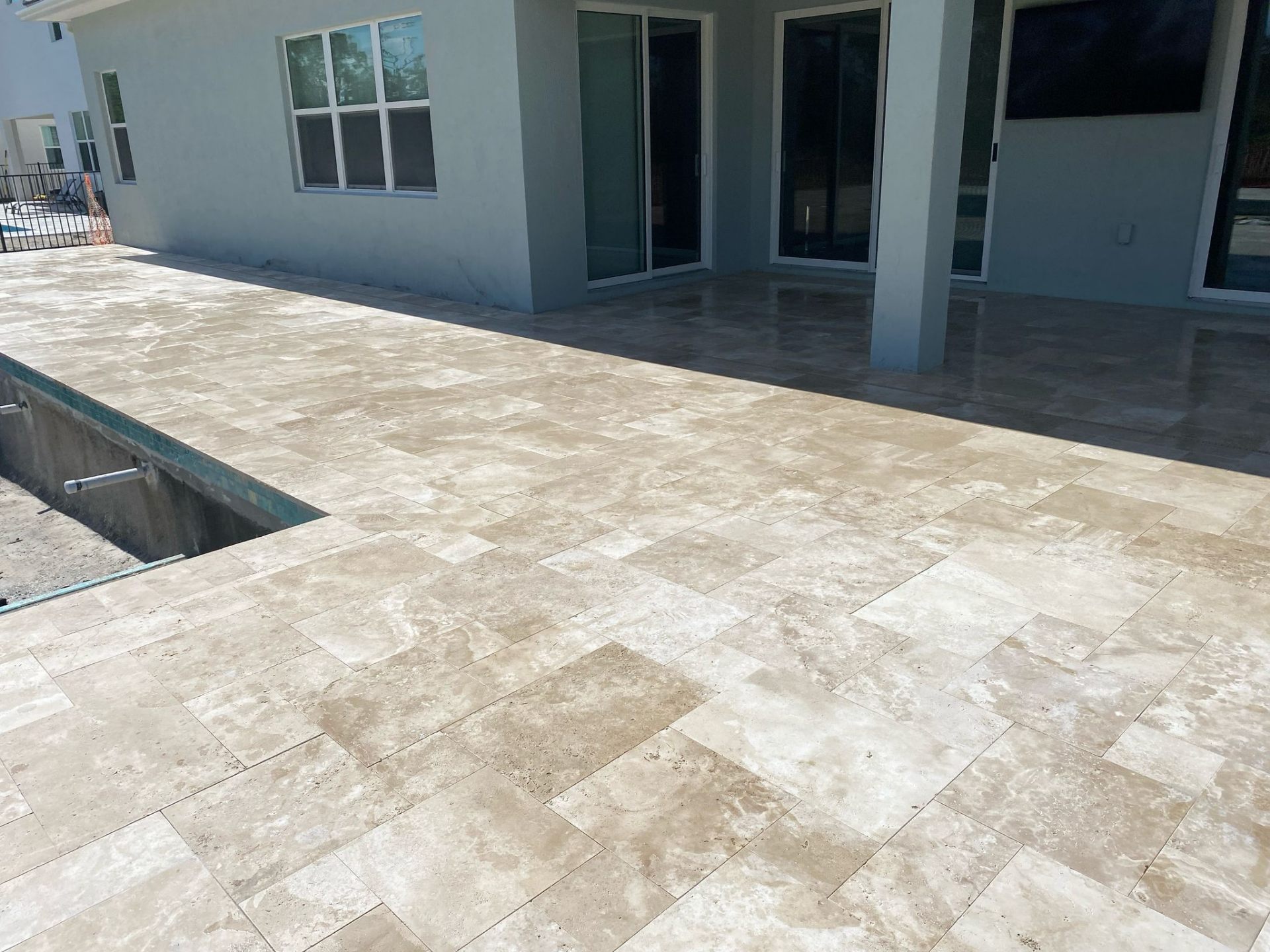 Travertine Pool Decks installation in South Florida by DMH Associates